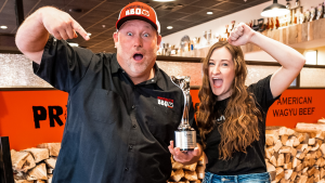 a female seo expert standing with a bbq pitmaster in Omaha
