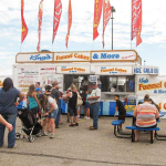 a funnel cake food truck with a line of people waiting at the nebraska state fair