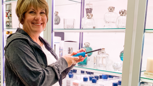 a white women lighting a lampe berge at a gift store in omaha