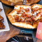 pizza and wings on a table