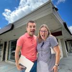 Two restaurant owners standing in front of a vacant building.