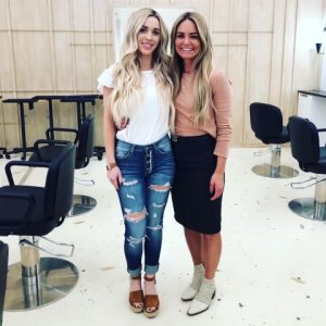 two women standing in a salon