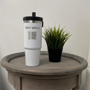a white tumbler sitting on a small table