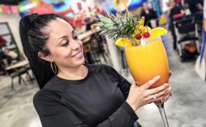 a female business owner holding a large drink