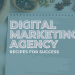 White Letter with the words Digital Marketing Agency recipes for success on a white notebook on a kitchen table surrounded by cooking condiments