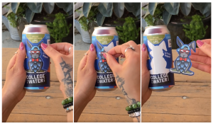 Three beer cans being held by a women who is peeling back stickers from the label. 